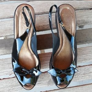 Black patent leather wedges.